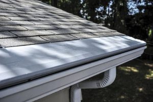 Edge of roof with gutters covered by gutter guards
