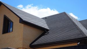 Close-up view of a home's roof with brown gutters